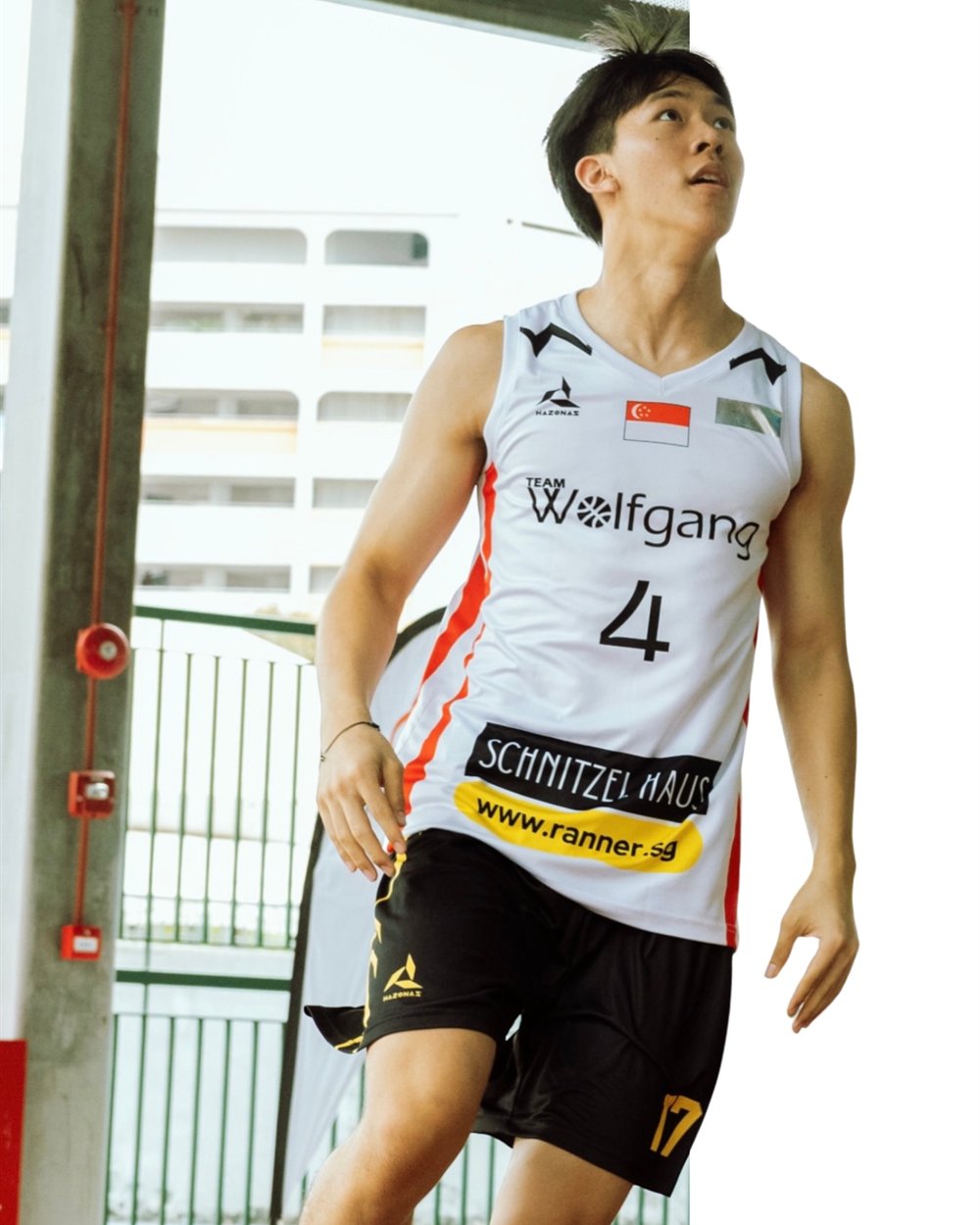 A Wolfgang SG player in the white number 4 jersey, Schnitzel Haus and www.ranner.sg printed across the front